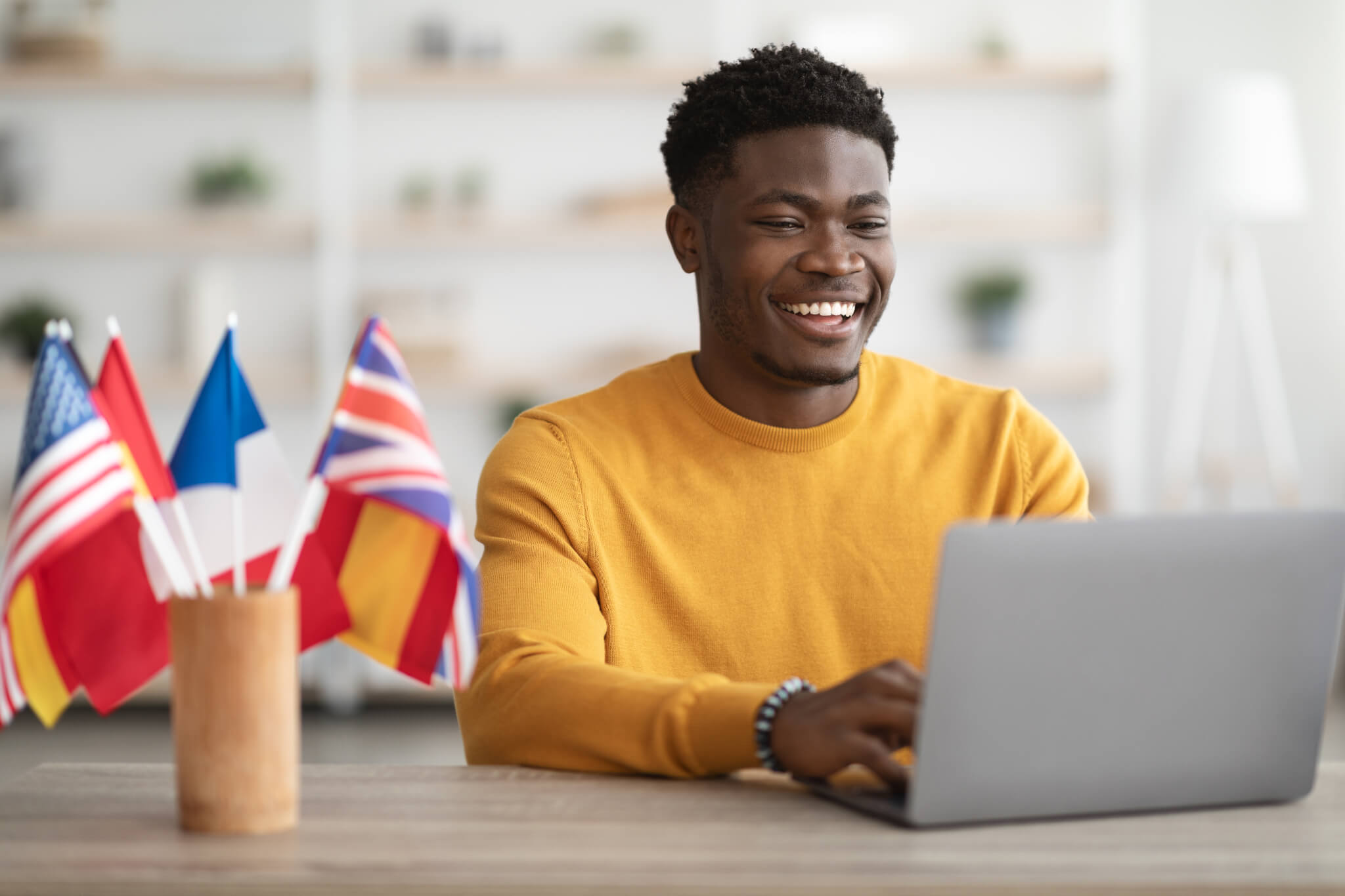 happy-black-guy-student-studying-at-language-school-online